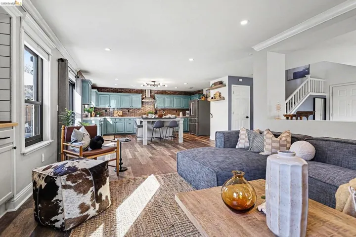 Living area featuring dark wood-style floors, recessed lighting, and crown molding