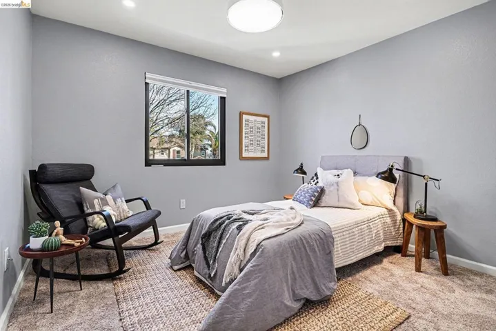Bedroom featuring light colored carpet and baseboards