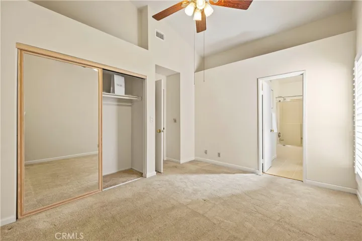Light filled second  bedroom with vaulted ceilings.