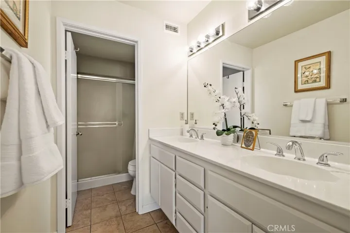 Expansive mirror, bright lighting , calm and refreshing.