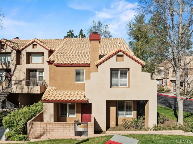 Front Porch, warm stucco exterior, and matured greenery.