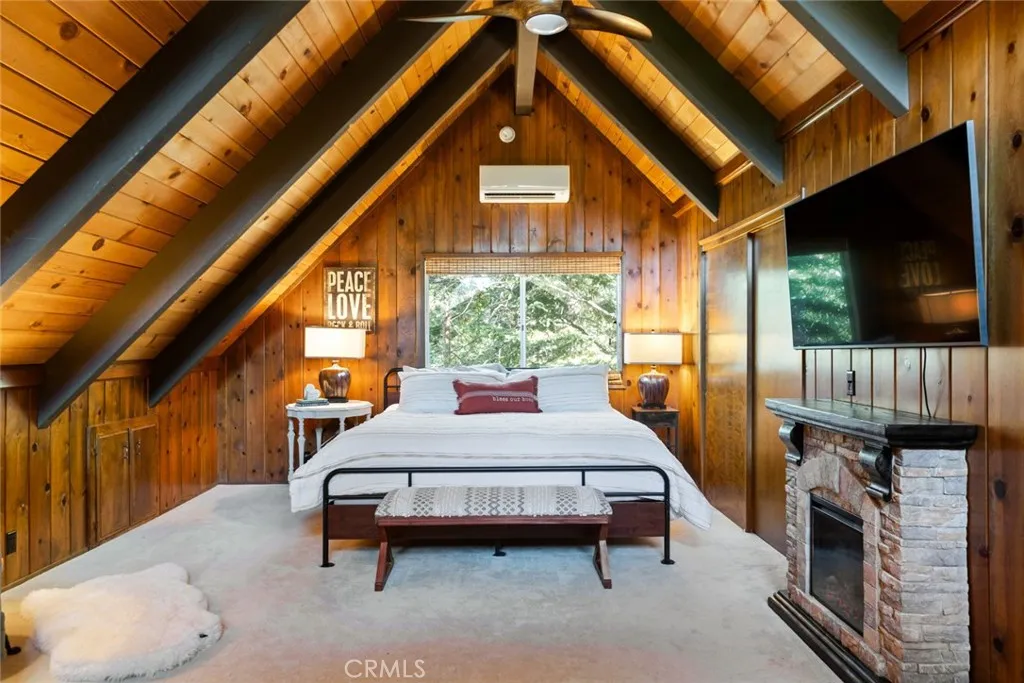 The upstairs bedroom features an en-suite bathroom, tongue & groove ceilings and idyllic A-frame cabin architecture. It also has its own mini-split!