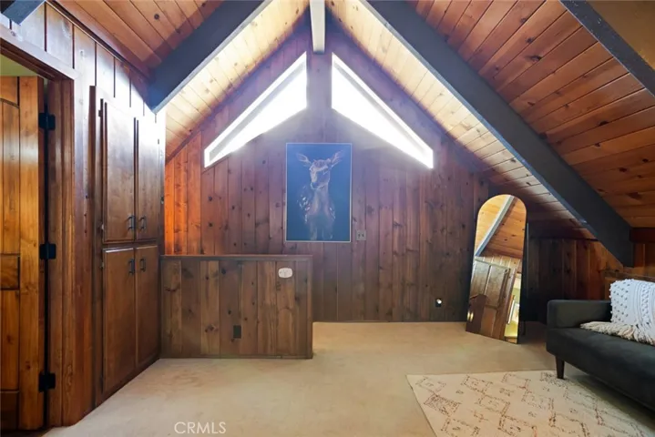 The upstairs bedroom features an en-suite bathroom, tongue & groove ceilings and idyllic A-frame cabin architecture. It also has its own mini-split!