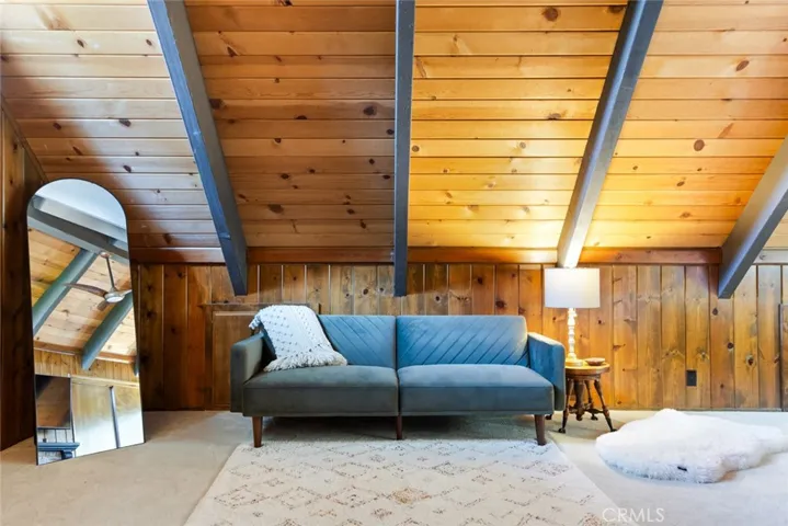 The upstairs bedroom features an en-suite bathroom, tongue & groove ceilings and idyllic A-frame cabin architecture. It also has its own mini-split!