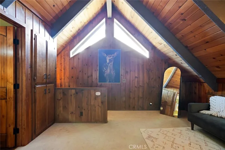 The upstairs bedroom features an en-suite bathroom, tongue & groove ceilings and idyllic A-frame cabin architecture. It also has its own mini-split!
