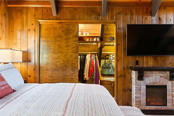 The upstairs bedroom features an en-suite bathroom, tongue & groove ceilings and idyllic A-frame cabin architecture. It also has its own mini-split!