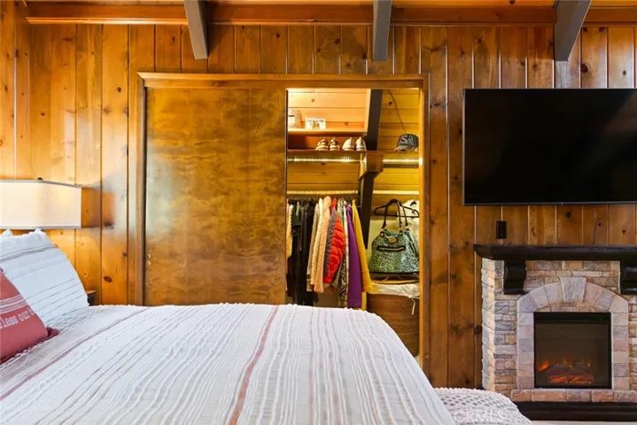The upstairs bedroom features an en-suite bathroom, tongue & groove ceilings and idyllic A-frame cabin architecture. It also has its own mini-split!