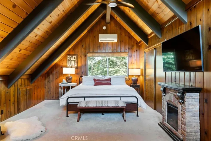 The upstairs bedroom features an en-suite bathroom, tongue & groove ceilings and idyllic A-frame cabin architecture. It also has its own mini-split!