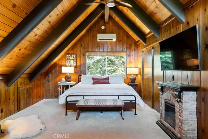 The upstairs bedroom features an en-suite bathroom, tongue & groove ceilings and idyllic A-frame cabin architecture. It also has its own mini-split!