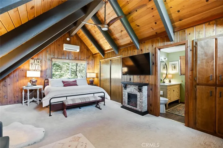 The upstairs bedroom features an en-suite bathroom, tongue & groove ceilings and idyllic A-frame cabin architecture. It also has its own mini-split!