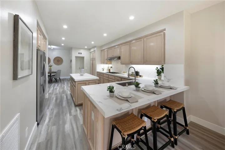 Expansive upgraded kitchen featuring 3-person breakfast counter, center kitchen island, and inclusive breakfast nook.