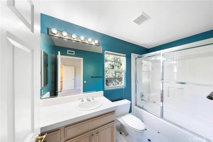 Private bathroom with tub in shower.