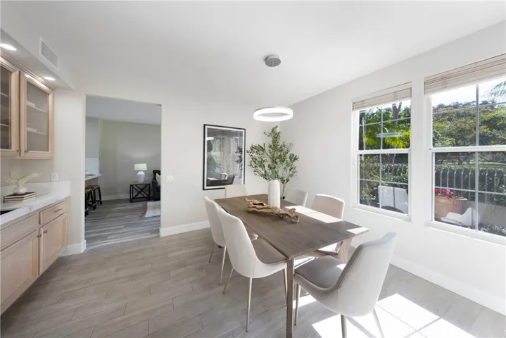 Natural light filled dining room with accompanying updated wet bar.