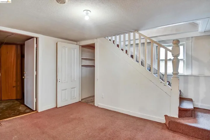 Below grade area featuring a textured ceiling and carpet