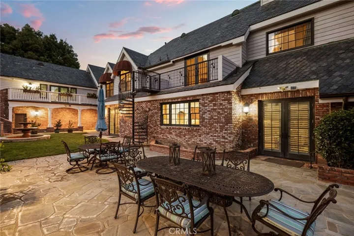 Backyard Seating Area with Spiral Staircase to the Primary