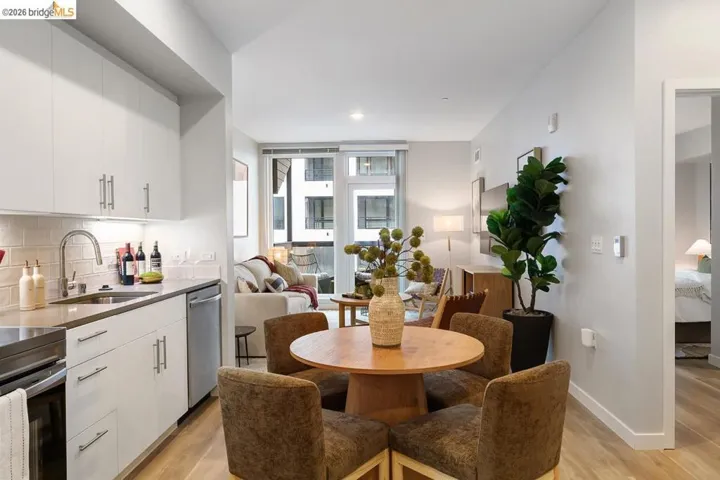 Dining room with light wood finished floors and recessed lighting