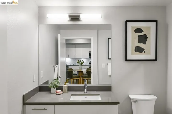 Bathroom featuring vanity and backsplash