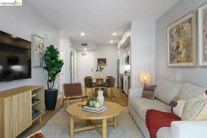 Living area with light wood-style floors and recessed lighting