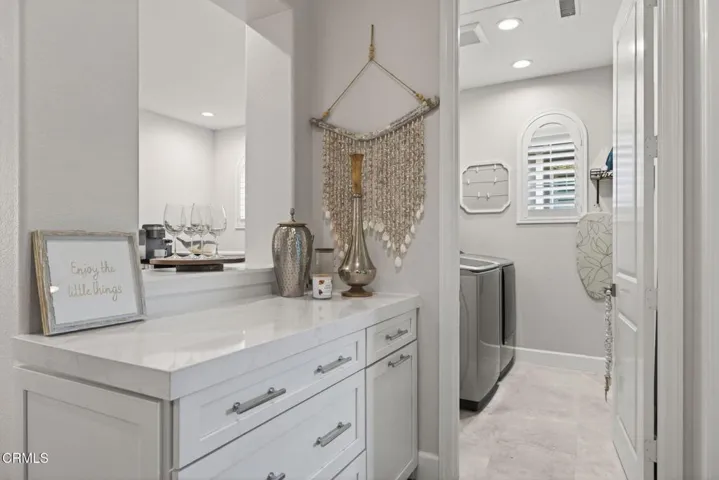 Linen storage leading to laundry room