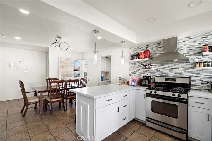 quartz countertops, glass mosaic tile backsplash