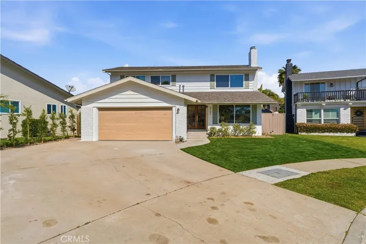 The front of the home with an oversized driveway.