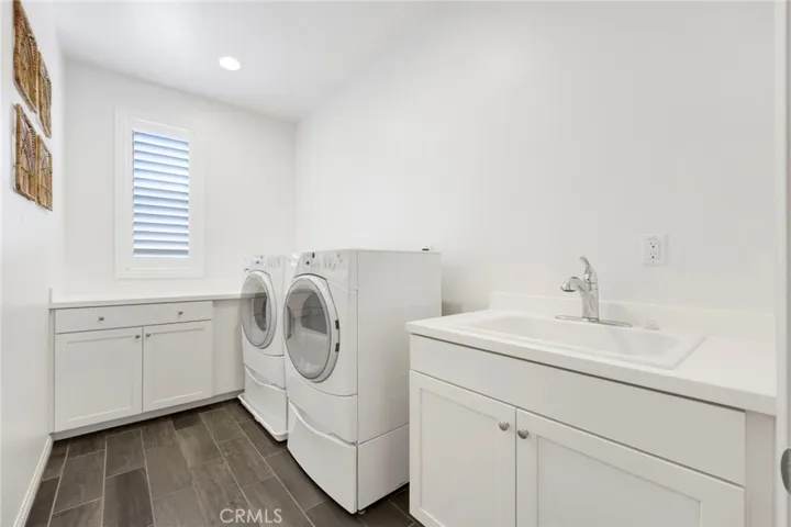 Utility room with included washer and dryer