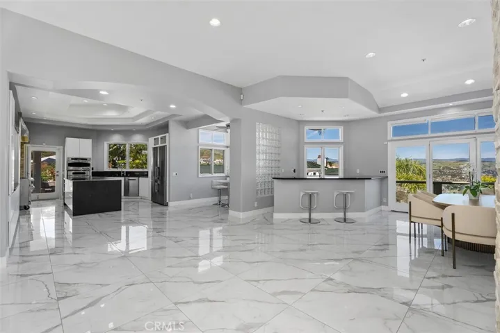 Great open concept, all new cabinets with easy-close doors and drawers, a wet bar and dining area in the kitchen all with spectaular views, in all direction.  Trey ceiling with recess lighting throughout. One must pay attention to the details of this house, there is just so much.
