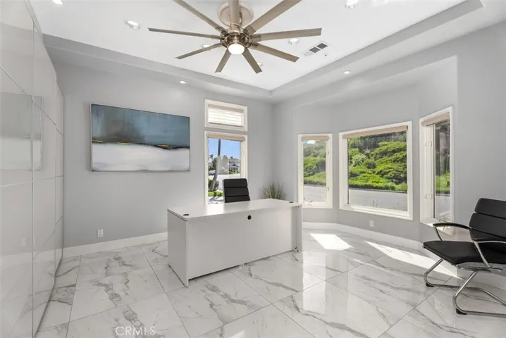 As you enter to the right is a spacious office space with built-ins from one wall to the next, overlooking wonderfully landsaped hillsides, high windows with plenty of natural lighting.  Shades retract all the way up to capture the full effect, if you want more privacy they can be completely closed but will still allow natural​​‌​​​​‌​​‌‌​​‌​​​‌‌​​​‌​​‌‌​​‌‌​​‌‌​​​​ light.