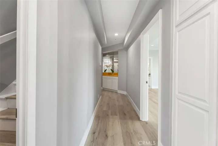 Downstairs, we have the remainer of the house with a laundry room, 4 Bedrooms, each with their own bathroom and doors to the exterior.  Great for multi-generational living. Hallway has an abundance of closets and additional storage.