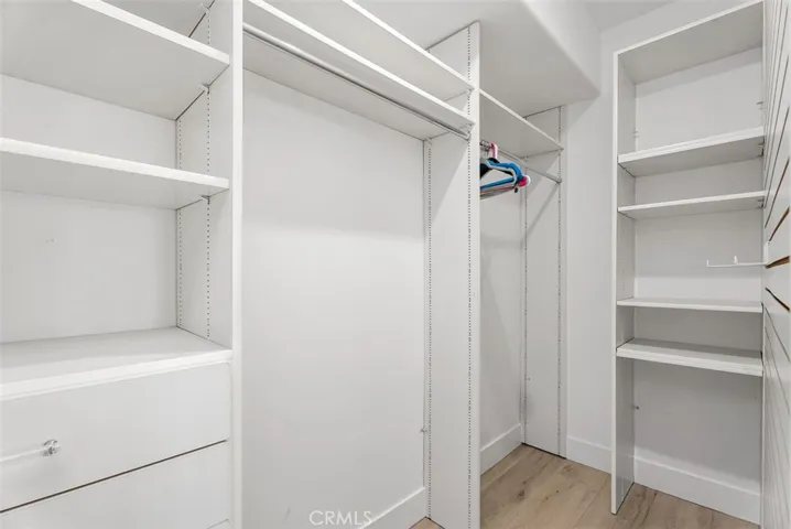 Walk-in closet in the third bedroom downstairs with built-ins. Lots of space and stoage.