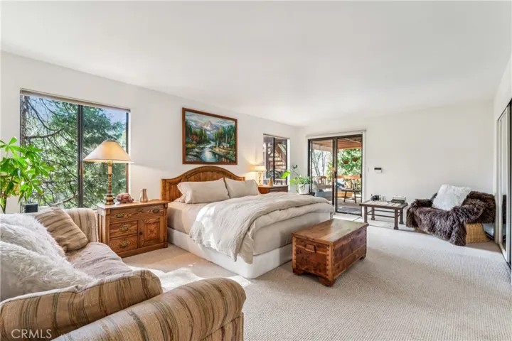 master retreat with deck access and seating area, and a wall of closets!