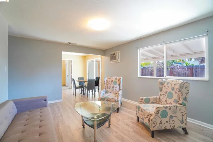 Living area with light wood-style floors and baseboards