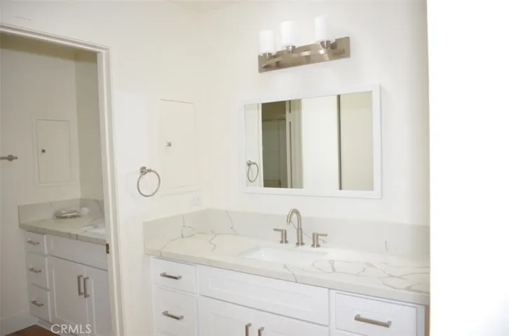 Double Primary Suite vanities - one in dressing area with NEW sinks, faucets, mirrors and light fixtures.