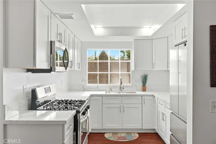 Kitchen with new floor and stainless-steel appliances