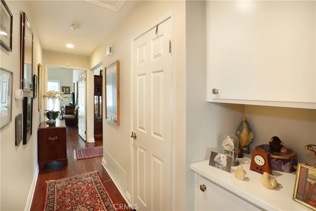 Hallway between the primary and secondary bedrooms. Storage and linen closet.