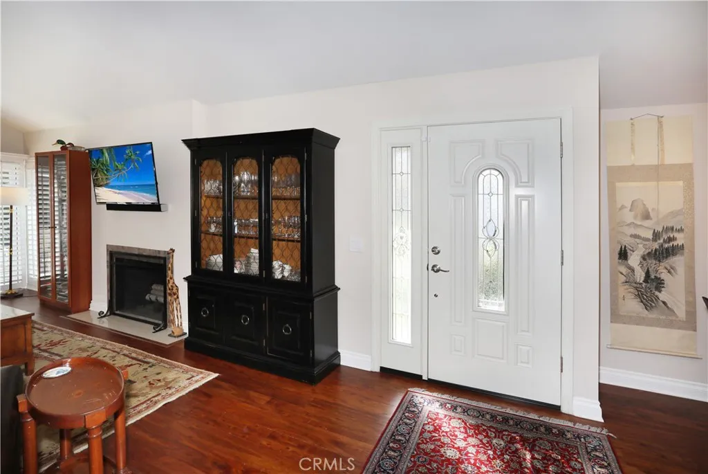 Entry door opens into the living room. The flooring is a beautiful eucalyptus veneer wood laminate.