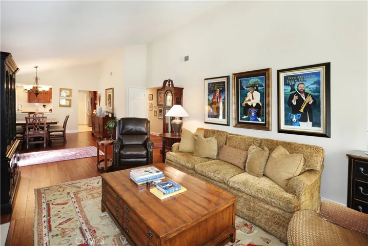 Living room is open to the dining area and vaulted ceilings maintain continuity.