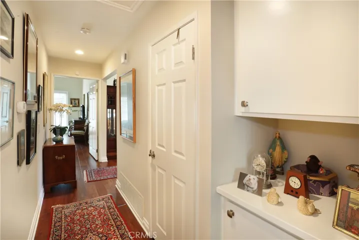 Hallway between the primary and secondary bedrooms. Storage and linen closet.