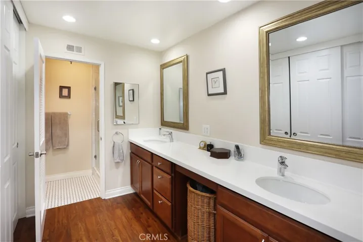 Primary bathroom has dual sinks and Quartz counters. A large closet with sliding doors is on the left.