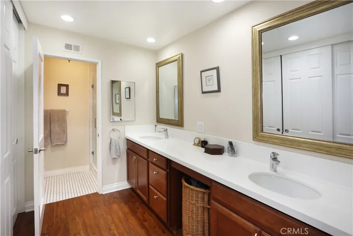 Primary bathroom has dual sinks and Quartz counters. A large closet with sliding doors is on the left.