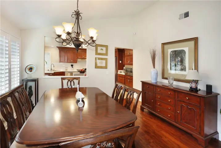 Spacious dining area and stylish overhead chandelier. Plantation shutters for light control.