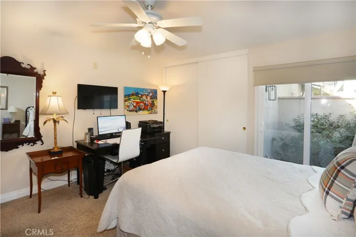 Even the secondary bedroom is spacious with a sliding glass door out to a small garden area.