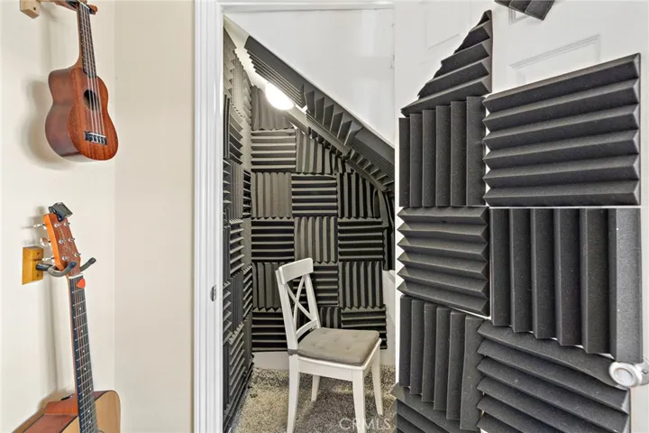 Storage closet under stairs can easily be converted back by sellers - currently used as private sound room.