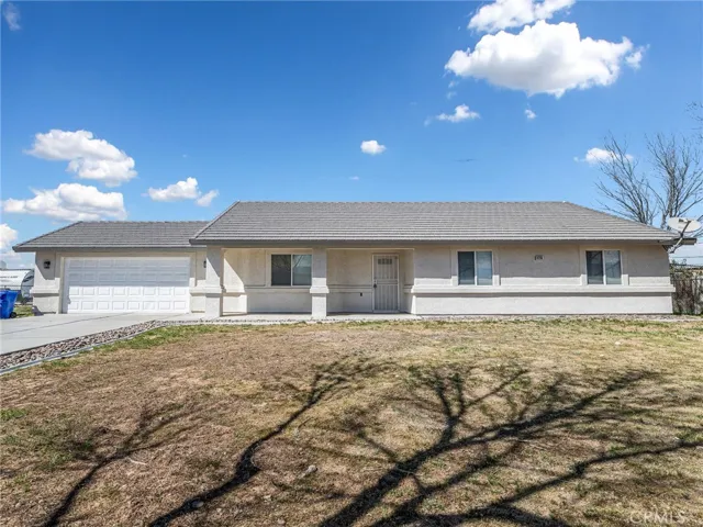 Clean curb appeal with a tile roof and expansive front yard.