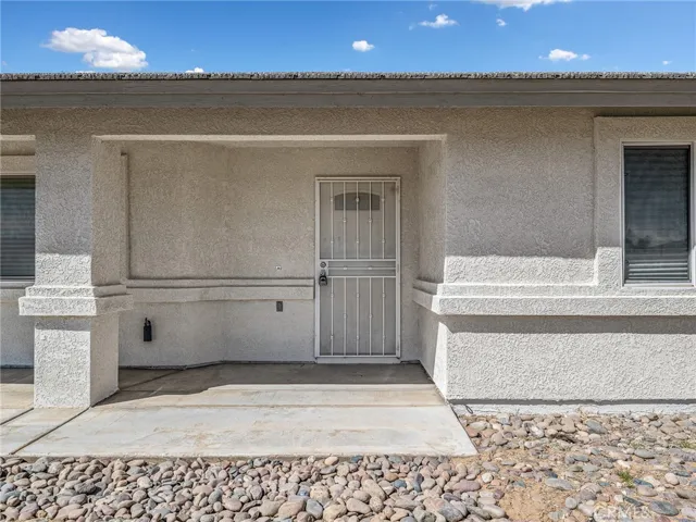 Inviting covered front door alcove offering shade, protection from the elements, and a welcoming entrance.
