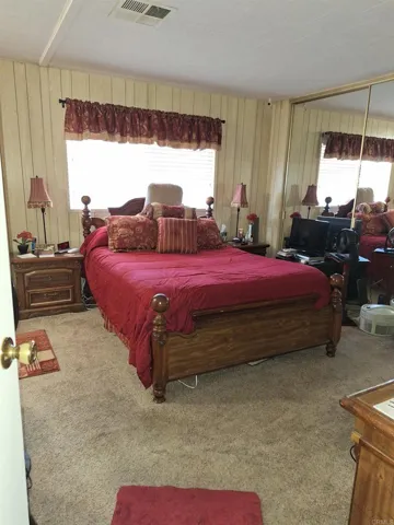 Large Master Bedroom with Mirrored Closet Doors
