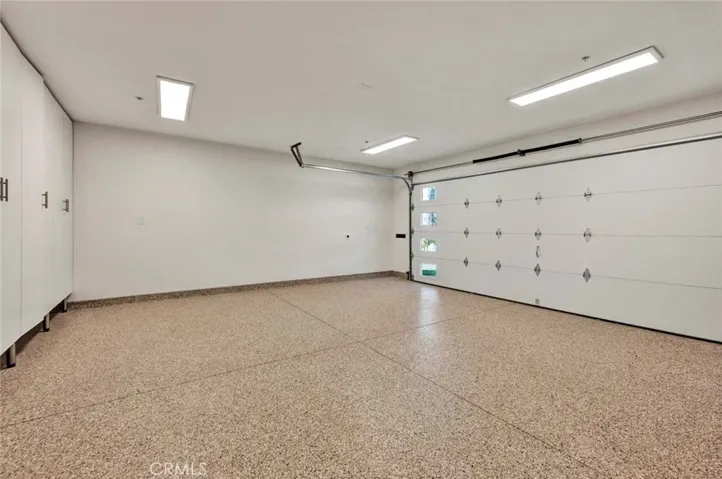 OVERSIZED TWO CAR GARAGE WITH EPOXY FLOORING AND DIRECT INTERIOR ACCESS