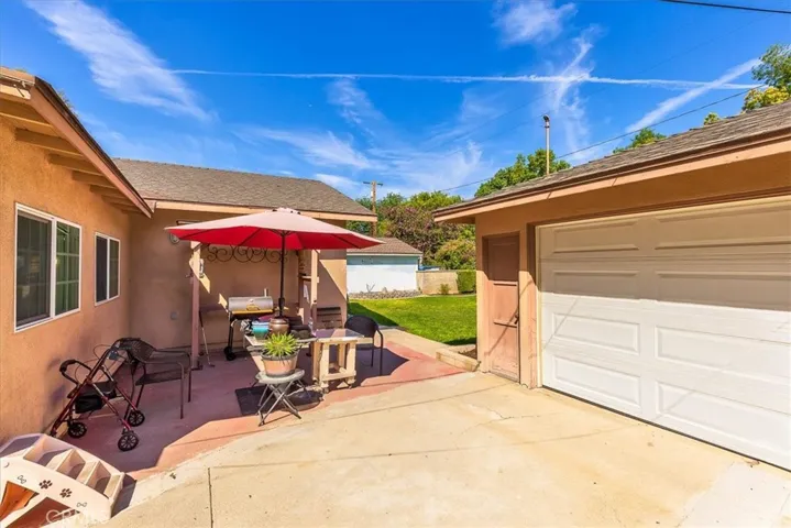 Patio area between the house and garage.