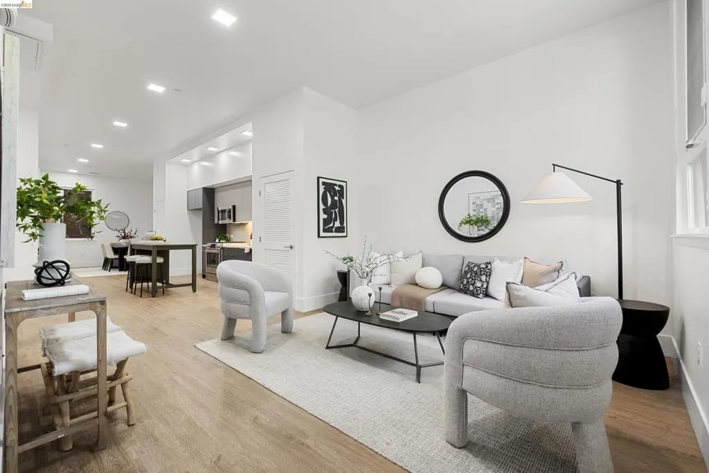 Living room with light wood-style floors and recessed lighting