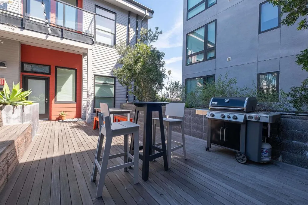 Expansive wood-finish deck with built-in bench seating and integrated planter